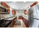 Bright kitchen featuring granite countertops, stainless steel appliances, and ample cabinet space at 3278 S Forest St, Denver, CO 80222