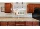 Kitchen view highlights granite countertops, wood cabinets, and pendant lighting at 3278 S Forest St, Denver, CO 80222