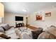 Comfortable living room featuring modern furnishings, an entertainment center, and seamless flow to the kitchen at 3278 S Forest St, Denver, CO 80222