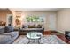 Cozy living room with hardwood floors, plush sofas, a large window, and a decorative rug at 3278 S Forest St, Denver, CO 80222