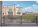A view from the balcony showcasing nearby residences, a green space, and a partially obscured sky at 11142 Bella Vita Dr, Broomfield, CO 80020