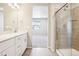 The bathroom has double sinks, a modern glass shower, and wood-look tile flooring for a sleek design at 11142 Bella Vita Dr, Broomfield, CO 80020