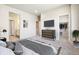 This primary bedroom features neutral walls, carpet floors, and a modern dresser with TV above at 11142 Bella Vita Dr, Broomfield, CO 80020
