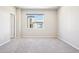 Empty bedroom featuring neutral carpet and paint, illuminated by natural light through a window showcasing an exterior view at 11142 Bella Vita Dr, Broomfield, CO 80020