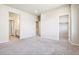 Bright, carpeted bedroom with entrances to the bathroom and walk-in closet for functionality at 11142 Bella Vita Dr, Broomfield, CO 80020