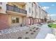 Attractive townhome featuring outdoor living with a balcony, brick accents, and a professionally landscaped walkway at 11142 Bella Vita Dr, Broomfield, CO 80020