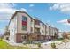 Beautiful townhome with brick and siding, enhanced by a manicured yard and welcoming pedestrian walkway at 11142 Bella Vita Dr, Broomfield, CO 80020