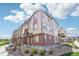 Attractive townhome featuring a blend of brick and siding, complemented by professionally landscaped grounds and a sidewalk at 11142 Bella Vita Dr, Broomfield, CO 80020