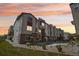 Modern townhome exterior featuring a multi-tone facade and professional landscaping at sunset at 11142 Bella Vita Dr, Broomfield, CO 80020