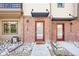Townhome entrance with red front door and decorative rock landscaping at 11142 Bella Vita Dr, Broomfield, CO 80020
