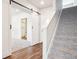 Upstairs hallway with carpet, a barn door, and a view into the bathroom at 11142 Bella Vita Dr, Broomfield, CO 80020