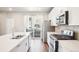 A kitchen with stainless steel appliances and white cabinets, offering a sleek and modern look with a balcony view at 11142 Bella Vita Dr, Broomfield, CO 80020