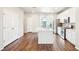 Spacious kitchen with stainless steel appliances, white cabinets, a functional island, and wood floors providing ample counter space at 11142 Bella Vita Dr, Broomfield, CO 80020