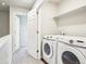 Bright laundry room featuring a modern washer and dryer set, providing convenience for laundry tasks at 11142 Bella Vita Dr, Broomfield, CO 80020