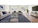 Bright living room featuring modern furniture, a plush rug, and large windows for ample natural light at 11142 Bella Vita Dr, Broomfield, CO 80020