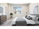 Cozy bedroom with neutral tones, a comfortable bed, a dresser, and a window overlooking an exterior view at 11142 Bella Vita Dr, Broomfield, CO 80020