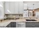 This kitchen includes granite counters, stainless appliances, white subway tile, and updated gray cabinets at 543 N Marion St, Denver, CO 80218