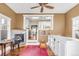 Living room with hardwood floors, a fireplace, built-in shelving, and an open doorway to the kitchen at 543 N Marion St, Denver, CO 80218