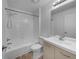 Bright bathroom with a shower over the tub and vanity with drawers and cabinets at 10699 Butte Dr, Longmont, CO 80504