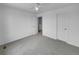 An airy bedroom features neutral carpet, white walls and multiple closets at 10699 Butte Dr, Longmont, CO 80504