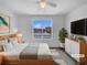 The main bedroom is virtually staged with large windows and bright, natural light at 10699 Butte Dr, Longmont, CO 80504