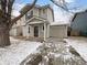 Charming two-story home with a covered front porch and attached garage at 10699 Butte Dr, Longmont, CO 80504