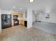 Bright kitchen features black appliances and light wood cabinets at 10699 Butte Dr, Longmont, CO 80504