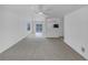 Open-concept living room features neutral carpet, and bright, white walls at 10699 Butte Dr, Longmont, CO 80504
