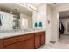 Bathroom featuring double sinks, a granite countertop, walk-in closet, and a glass enclosed shower at 3659 Makley Cir, Castle Rock, CO 80104
