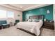 Cozy bedroom featuring a teal accent wall, a large window and carpeted floors at 3659 Makley Cir, Castle Rock, CO 80104