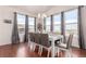 Bright dining room with hardwood floors, large windows, and modern chandelier at 3659 Makley Cir, Castle Rock, CO 80104