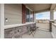 Cozy front porch with decorative stone accents, seating, and a lovely view of the surrounding neighborhood at 3659 Makley Cir, Castle Rock, CO 80104