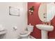 Charming half-bathroom with pedestal sink and decorative wall art at 3659 Makley Cir, Castle Rock, CO 80104