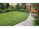 Back yard with manicured lawn bordered by stone pathway and flowers at 615 N Williams St, Denver, CO 80218