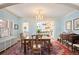 Bright dining room features a chandelier, large table, and opens to the kitchen at 615 N Williams St, Denver, CO 80218