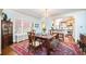 Bright dining room features a chandelier, large table, and opens to the kitchen at 615 N Williams St, Denver, CO 80218