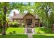 Charming single-Gathering home boasts an inviting front porch and beautifully landscaped front yard at 615 N Williams St, Denver, CO 80218