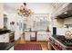 Charming kitchen with a farmhouse sink, stainless steel appliances, and red patterned rug at 615 N Williams St, Denver, CO 80218
