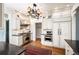 Beautiful kitchen featuring custom white cabinets, stainless steel appliances, and unique chandelier at 615 N Williams St, Denver, CO 80218