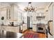 Gourmet kitchen featuring custom white cabinetry, stainless steel appliances, and a farmhouse sink at 615 N Williams St, Denver, CO 80218