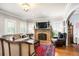 Cozy living room featuring a decorative fireplace, hardwood floors, and large windows at 615 N Williams St, Denver, CO 80218