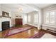 Bright living room with hardwood floors, fireplace, and large windows with charming shutters at 615 N Williams St, Denver, CO 80218