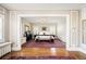 Large primary bedroom with wood floors and a red patterned rug at 615 N Williams St, Denver, CO 80218