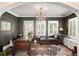 Well-lit office features a stylish chaise lounge, elegant chandelier, and classic shuttered windows at 615 N Williams St, Denver, CO 80218