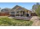 Spacious backyard exterior with patio, outdoor seating, lush lawn, and well-maintained landscaping at 20040 E Doane Dr, Aurora, CO 80013