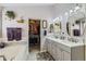 Elegant bathroom with a double sink vanity, soaking tub, and walk-in closet, creating a luxurious experience at 20040 E Doane Dr, Aurora, CO 80013