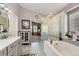 Chic bathroom with a soaking tub, glass shower, and neutral tile, providing a clean and stylish ambiance at 20040 E Doane Dr, Aurora, CO 80013
