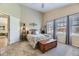 Bright bedroom with plush carpet, large windows, and a wooden chest, providing ample space and comfort at 20040 E Doane Dr, Aurora, CO 80013
