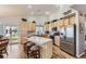Modern kitchen with stainless steel appliances, granite countertops, and breakfast bar with seating at 20040 E Doane Dr, Aurora, CO 80013