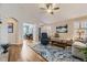 Inviting living room featuring an open layout, hardwood floors, and view into bright office space at 20040 E Doane Dr, Aurora, CO 80013